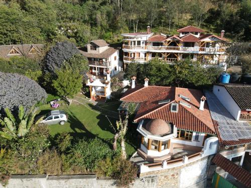 an aerial view of a house with a white truck parked in front at Hostal Mamá Hilda in Chugchilán