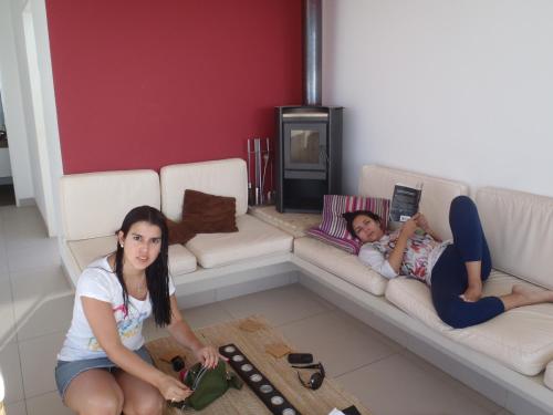 two girls laying on a couch in a living room at Paracas top tower beach front in Paracas