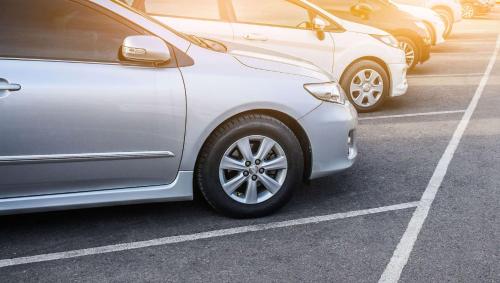 a row of parked cars in a parking lot at Hometown Inn Staunton in Greenville