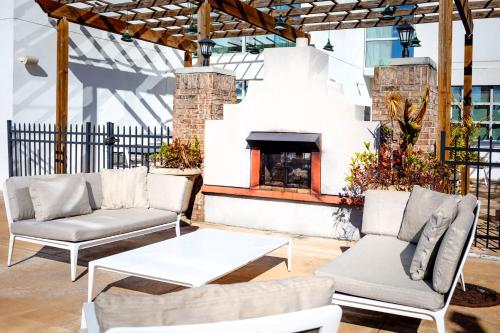 a patio with two couches and a fireplace at Crowne Plaza Charleston by IHG in Charleston