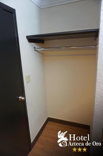 a room with a closet with a door at Hotel Azteca de Oro Mexicali in Mexicali