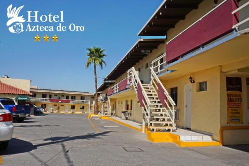 a hotel with a staircase outside of a building at Hotel Azteca de Oro Mexicali in Mexicali