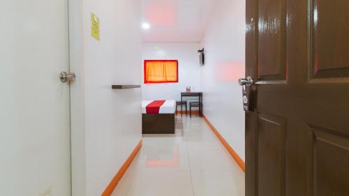 a hallway with a door and a room with a table at RedDoorz @ EL Runway Hotel Bulacan in Bulacan