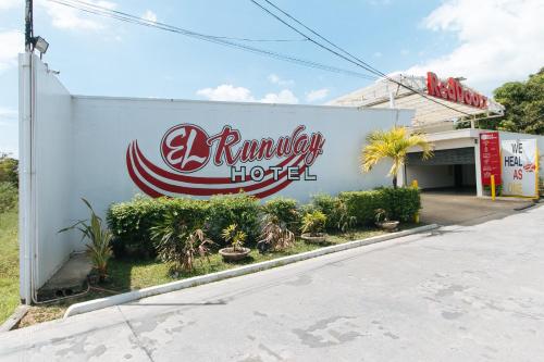 a building with a sign on the side of it at RedDoorz @ EL Runway Hotel Bulacan in Bulacan