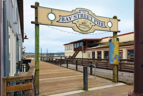 a sign for the bay street pier on a boardwalk at Holiday Inn Express Newport by IHG in Newport