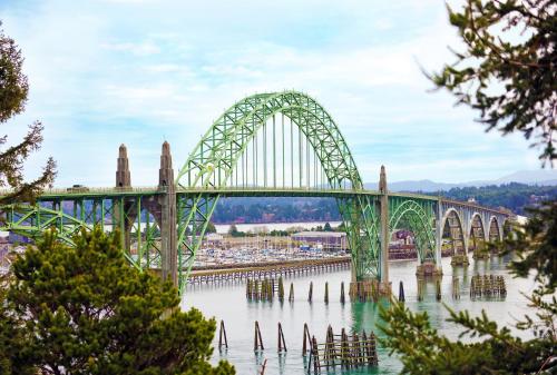 a bridge over the water with trees in the foreground at Holiday Inn Express Newport by IHG in Newport