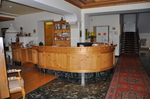 a large wooden table in a large room at Hotel Dolomiten in Dobbiaco
