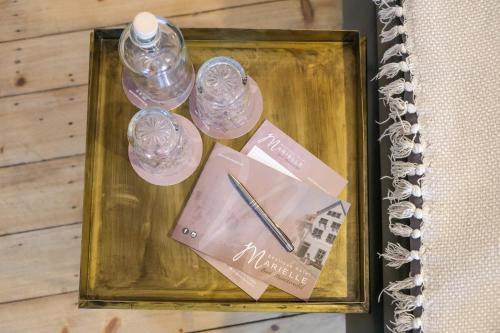 a picture of two bottles of water and a pen at Boutique Hotel Marielle in Bad Münstereifel