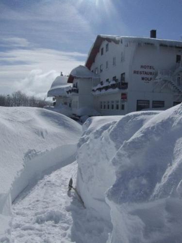 a pile of snow next to a building at Hôtel Restaurant Wolf in Markstein 