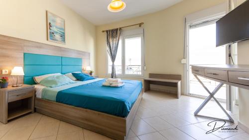 a bedroom with a blue bed and a kitchen at Diamanti Villa, Pool & Barbecue in Skala Potamias