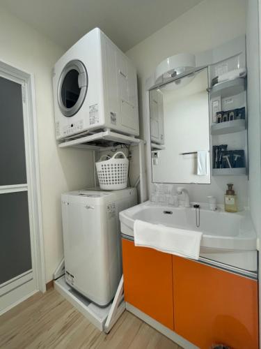a kitchen with a sink and a washing machine at HOTEL Ishigakijima 2020 in Ishigaki Island