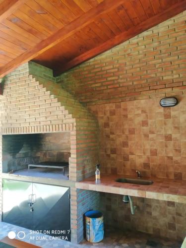 a kitchen with a counter and a brick wall at CASA FUNES in Funes