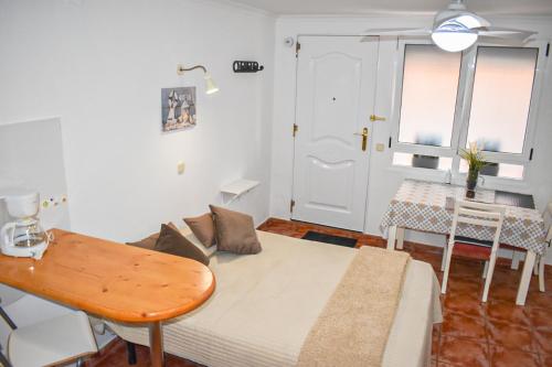 a living room with a couch and a table at Beachback Studio Airport in La Garita