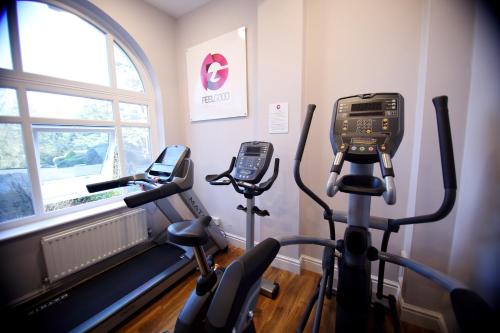 a gym with two exercise bikes in a room at Mercure Gloucester Bowden Hall Hotel in Gloucester