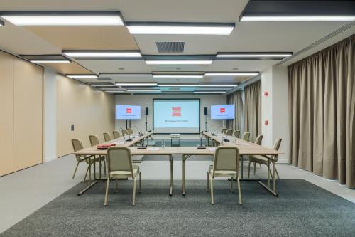 a conference room with a long table and chairs at ibis Timisoara City Center in Timişoara
