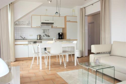 a kitchen and living room with a table and chairs at GODS06108-FeWo-Moeoev in Gollendorf