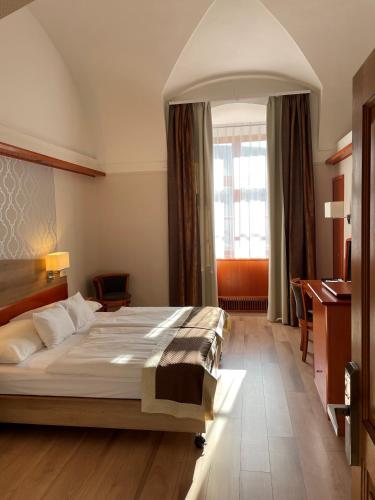 a bedroom with a large bed in a room at Gizella Hotel and Restaurant in Veszprém