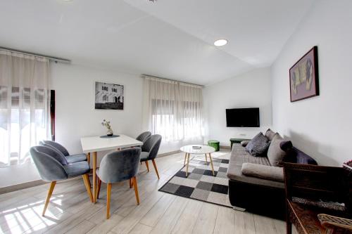 a living room with a couch and chairs and a table at Villa Fortuna in Mostar