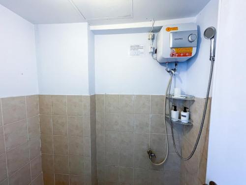 a shower stall in a bathroom with a shower at Green Bay Pluit Apartment - Seaview Studio Fast Wifi in Jakarta