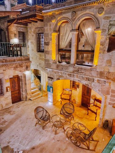 a room with chairs and tables in a building at Charming Cave Hotel in Goreme