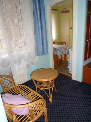 a room with a table and two chairs and a table at Penzion Paradise in Ostrava