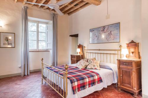 a bedroom with a bed and a window at Villa Cenami Apartments with BIG POOL in Massarosa