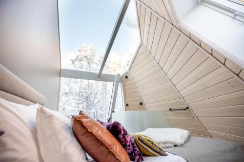 a bedroom with a bed and a large window at Glass Resort in Rovaniemi