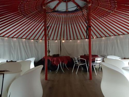 a red and white tent with white tables and chairs at Albavillage Hotel Wellness & Camping in Alba