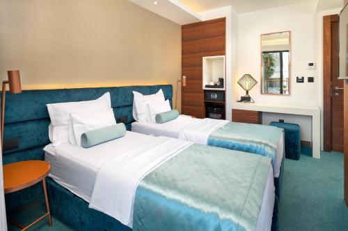 a hotel room with two beds and a table at Time Boutique Hotel in Split