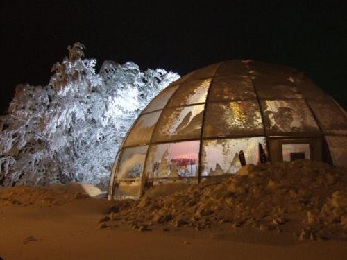 a large domed building in the sand at night at Hôtel Restaurant Wolf in Markstein 