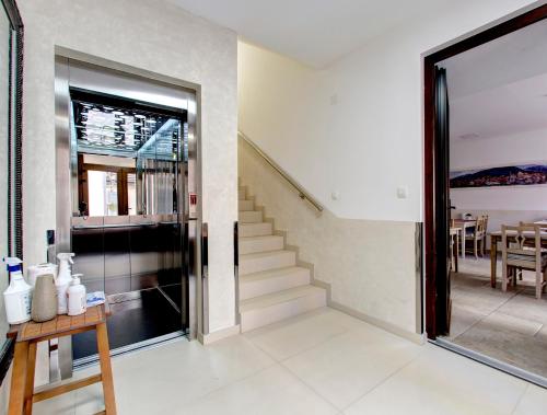 a room with a staircase and a glass door at Villa Fortuna in Mostar