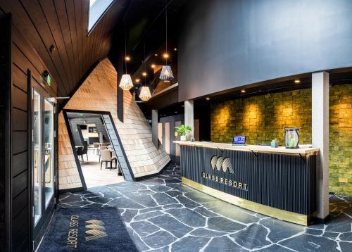 a restaurant with a counter in the middle of a building at Glass Resort in Rovaniemi