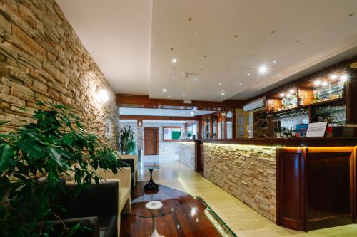 a bar in a restaurant with a brick wall at Irish House Međugorje in Međugorje