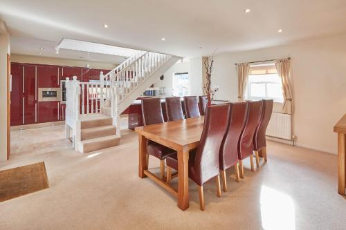 a dining room with a wooden table and chairs at Host & Stay - Folkton Cottages in Scarborough