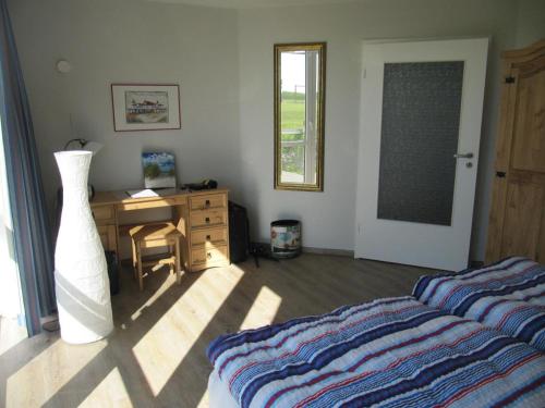a bedroom with a desk and a bed and a dresser at Der Landhof Seeadler in Stolpe auf Usedom
