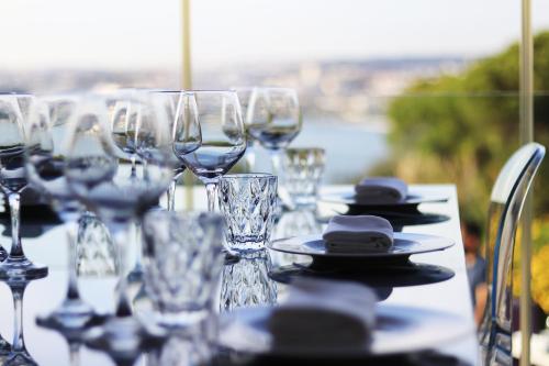 a table with wine glasses and plates on it at Quinta Tagus in Costa da Caparica