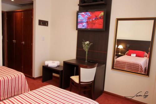 Postel nebo postele na pokoji v ubytování Grand Hotel Libertad