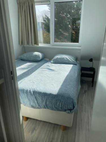 2 aparte bedden in een kamer met een raam bij KASITA12 in Domburg