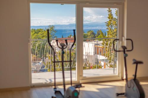 a room with a large window looking out at the ocean at Luxury Villa Rivabel in Malinska