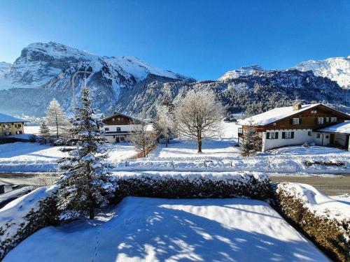 a snow covered village with mountains in the background at Apartment Casa Milu by Interhome in Engelberg