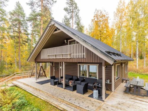 a cabin in the woods with a wooden deck at Holiday Home Ranta 3 by Interhome in Vääksy