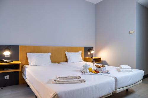 Кровать или кровати в номере Flag Hotel Braga