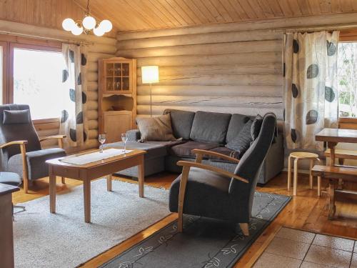 sala de estar con sofá y mesa en Holiday Home Kalliohonka by Interhome, en Torvoila