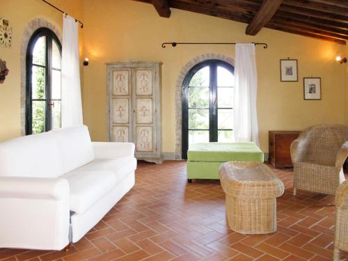 a living room with a white couch and chairs at Holiday Home Santa Enerichetta by Interhome in Pomarance