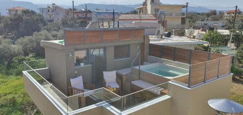 a house with a swimming pool on top of it at Blueonar in Chania