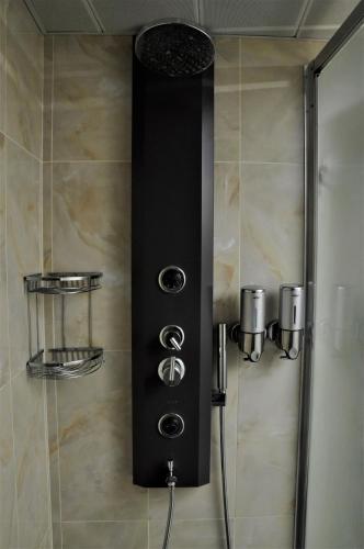 a shower with a black control panel in a bathroom at Kosa boutique hotel in Antalya