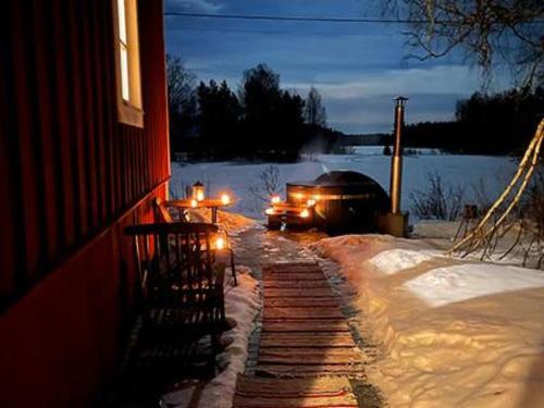 a truck driving down a snow covered street at night at Holiday Home Virtaan väentupa by Interhome in Nuoramoinen
