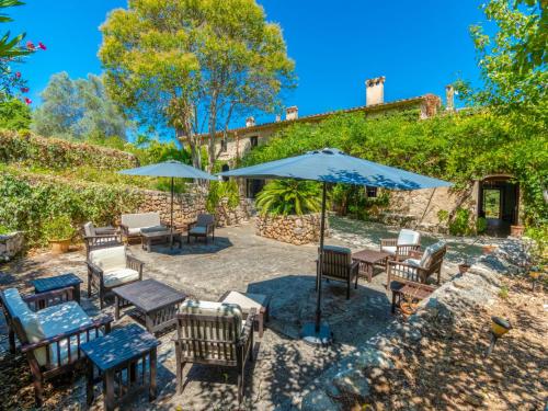 eine Terrasse mit Tischen, Stühlen und Sonnenschirmen in der Unterkunft Holiday Home Varitx Paradise by Interhome in Pollença