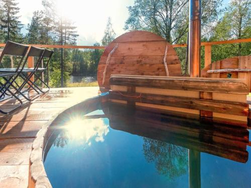 a pool of water with a bench on a deck at Holiday Home Koivu by Interhome in Sonkajärvi