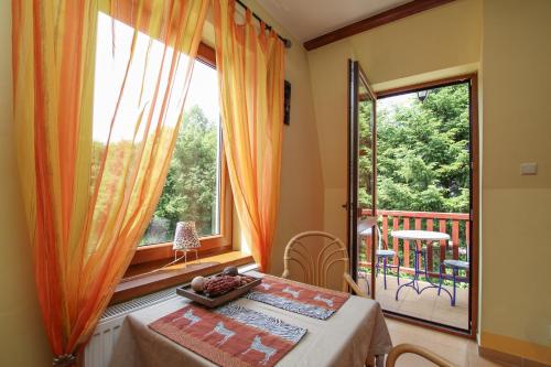 a dining room with a table and a large window at Apartment 4 in Rewal